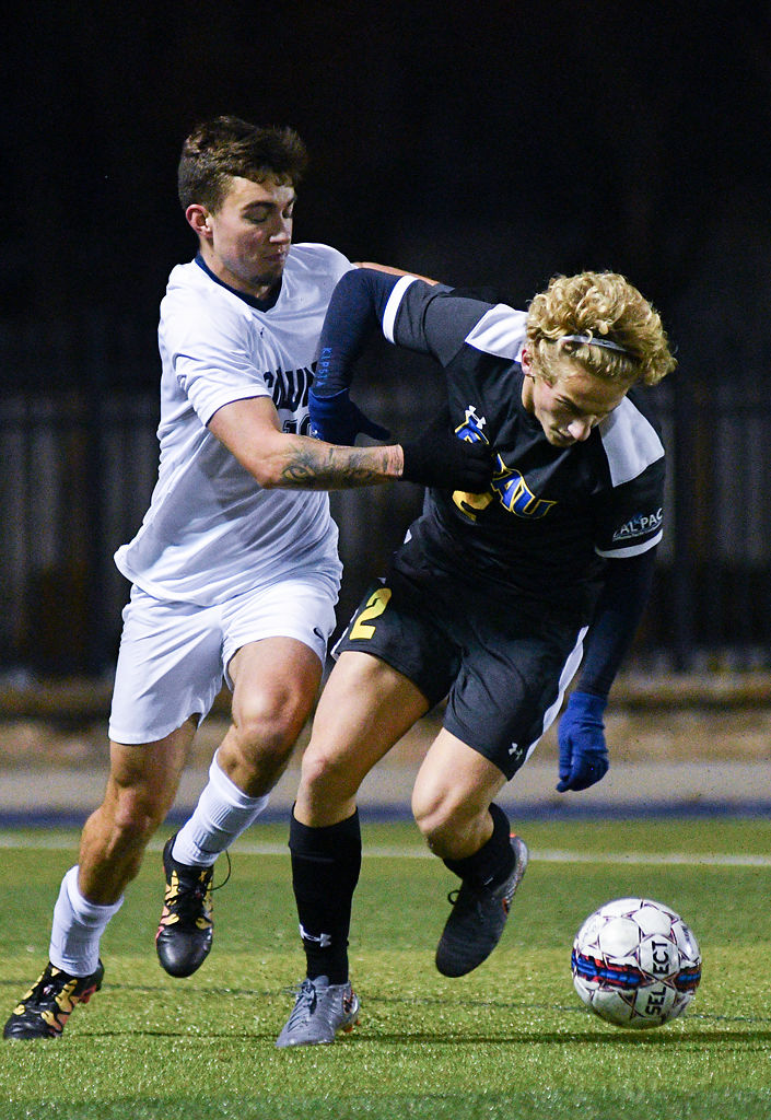 Ximo Gill and Sergio Monteiro challenge for possession